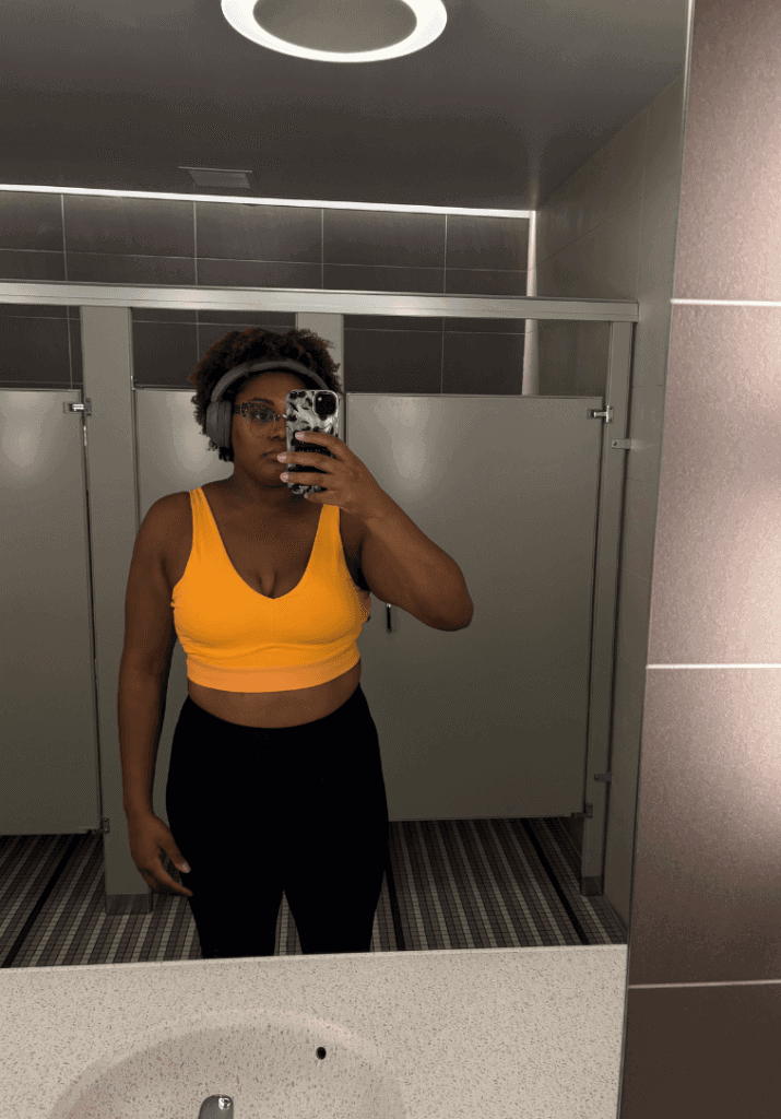 Brianna Imani showing her fitness transformation in a mirror picture 