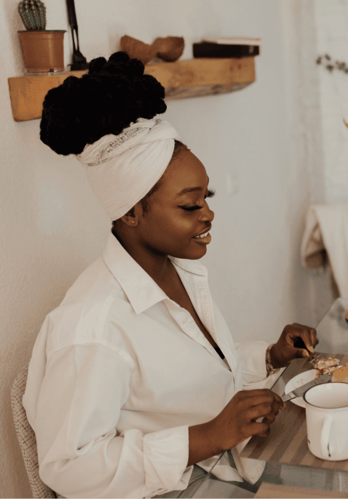 A woman eating breakfast and knowing the importance of rest days in fitness