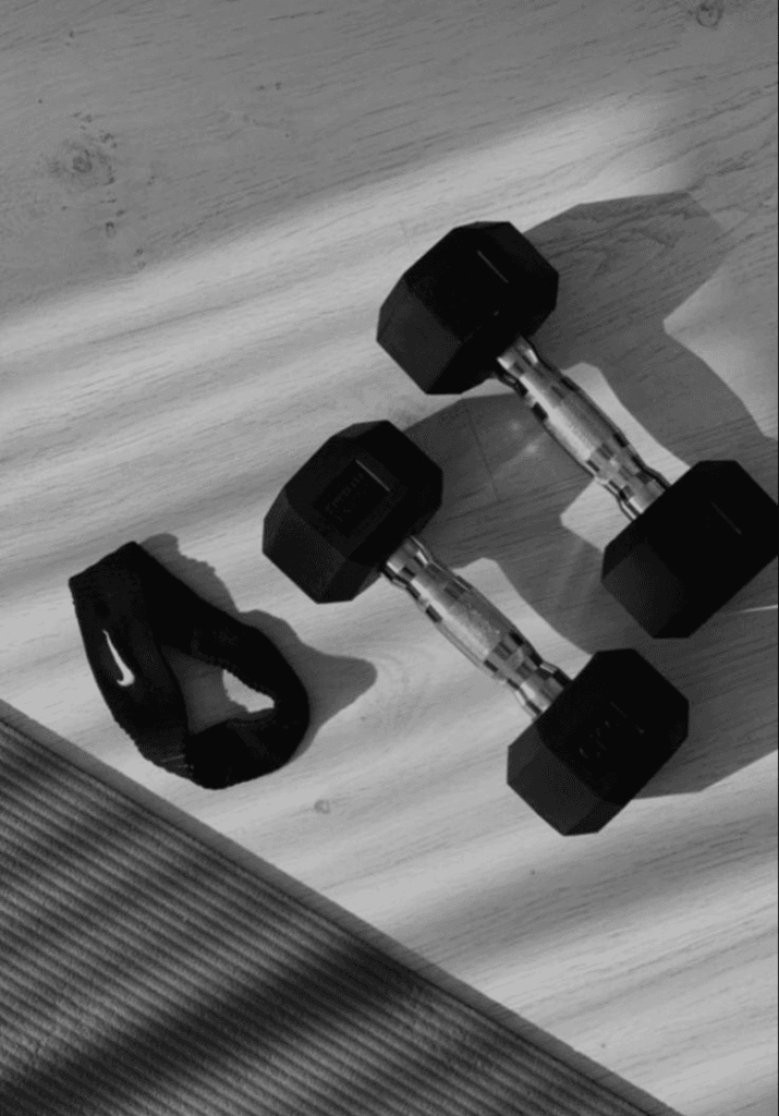 Showing dumbells and a sweatband showing tools needed on a fitness transformation journey
