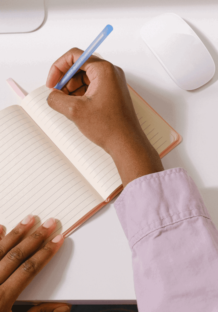 a woman using a notepad to organize her life. 