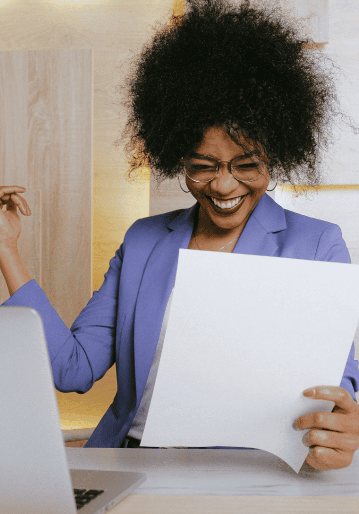 A woman smiling and working on building productivity systems