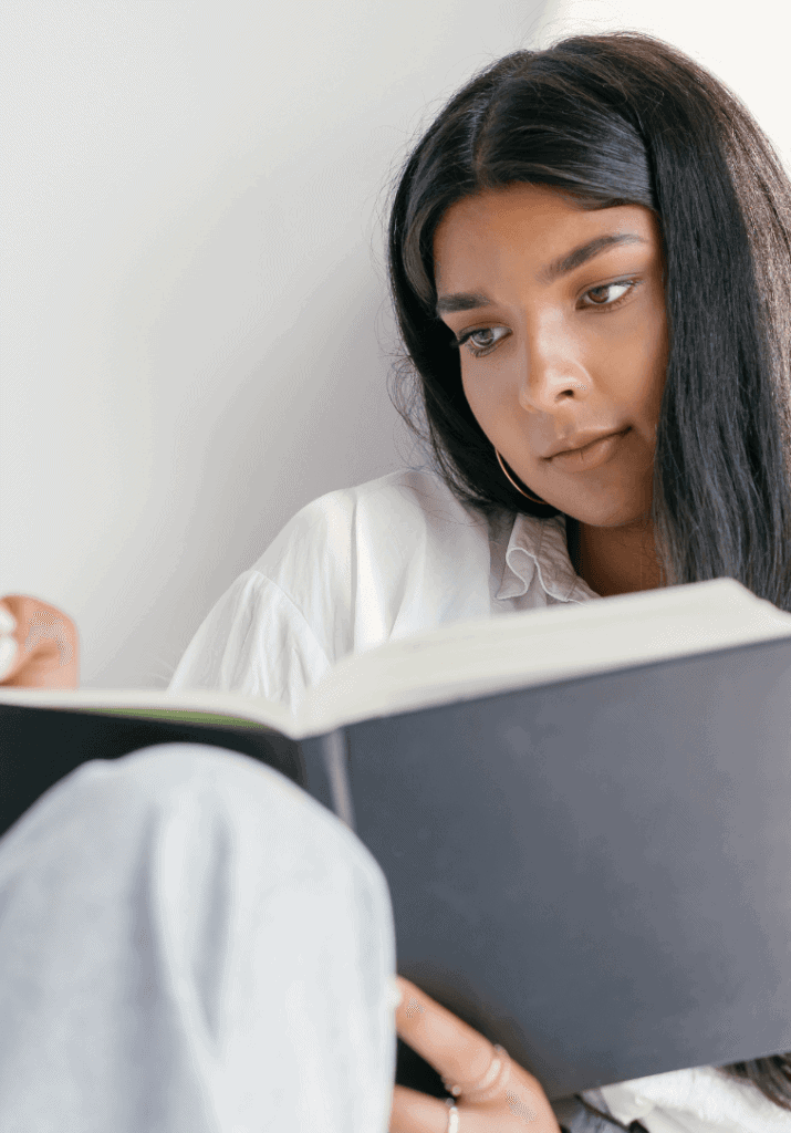 a woman resetting on Sunday by planning in her planner