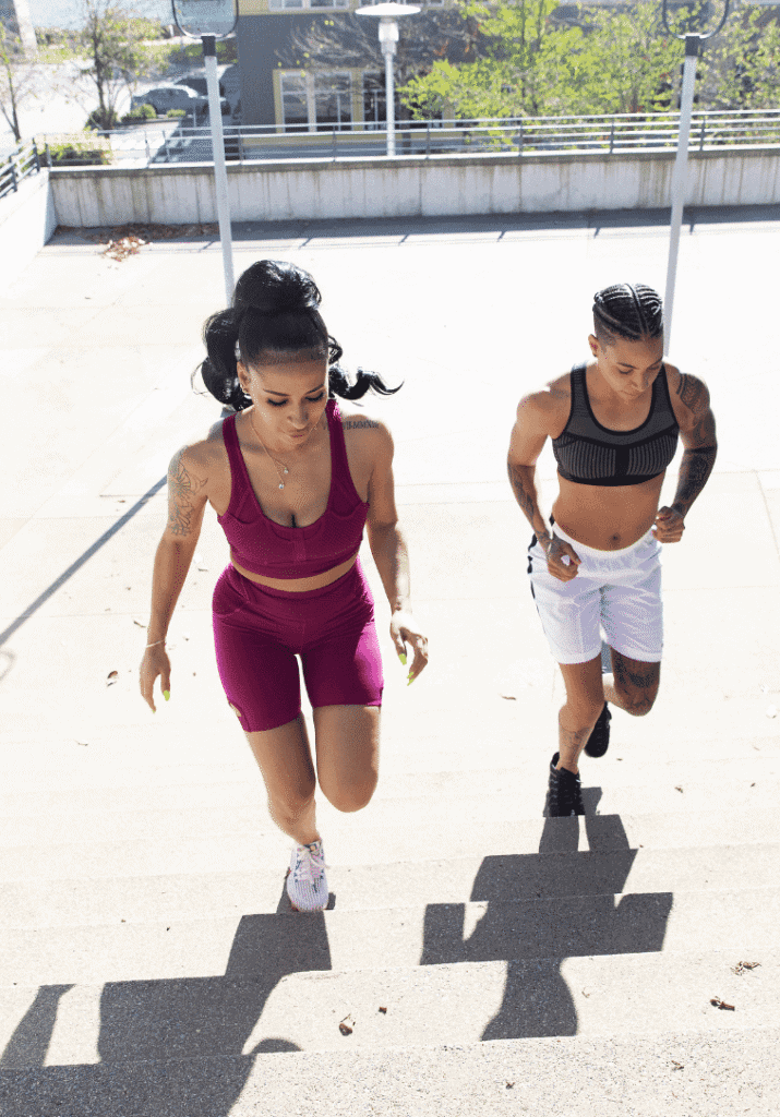 Two women powering through their beginner workout routine with stair runs.