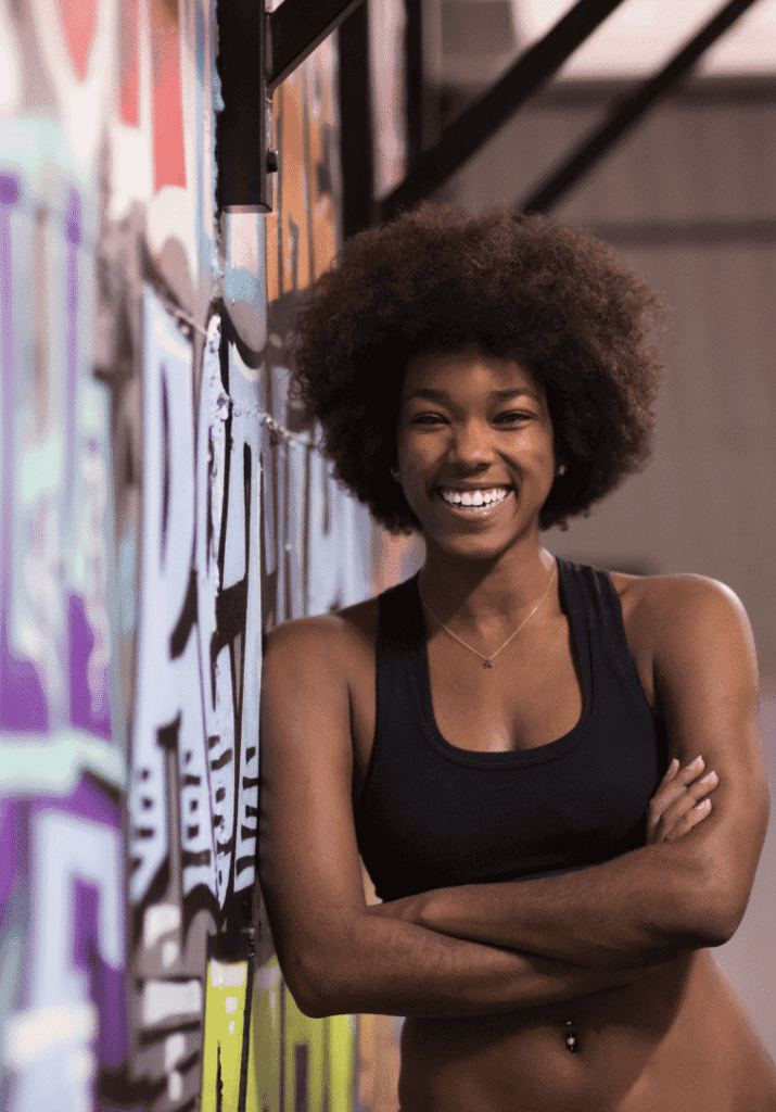 a black woman smiling about getting back into a fitness routine