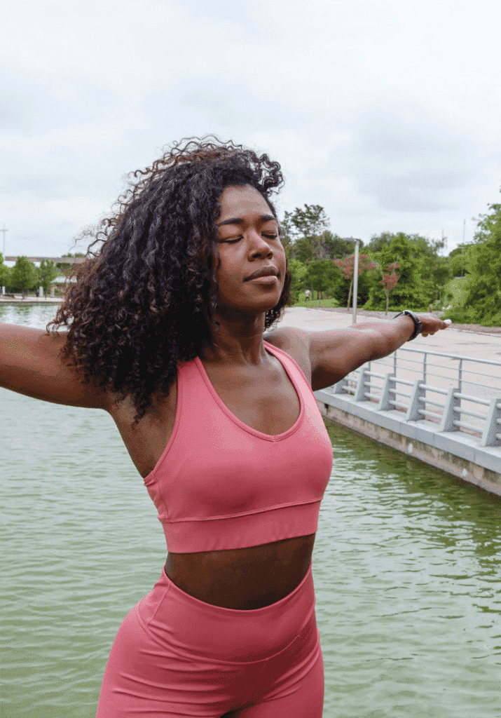 a black woman stretching her arms out