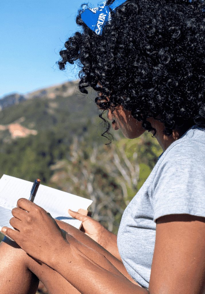 black girl journaling to handle stress naturally