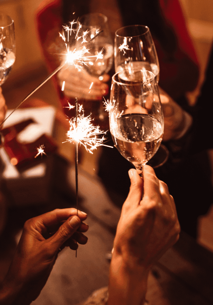 people holding sparklers and toasting to a new year reset routine