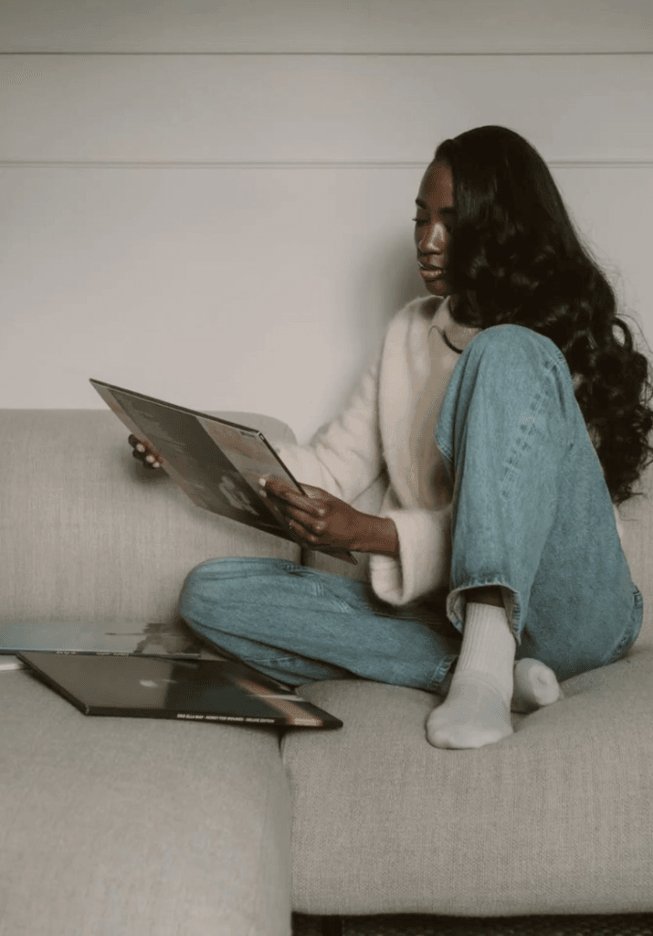 a woman looking at a vinyl record and prioritizing  herself