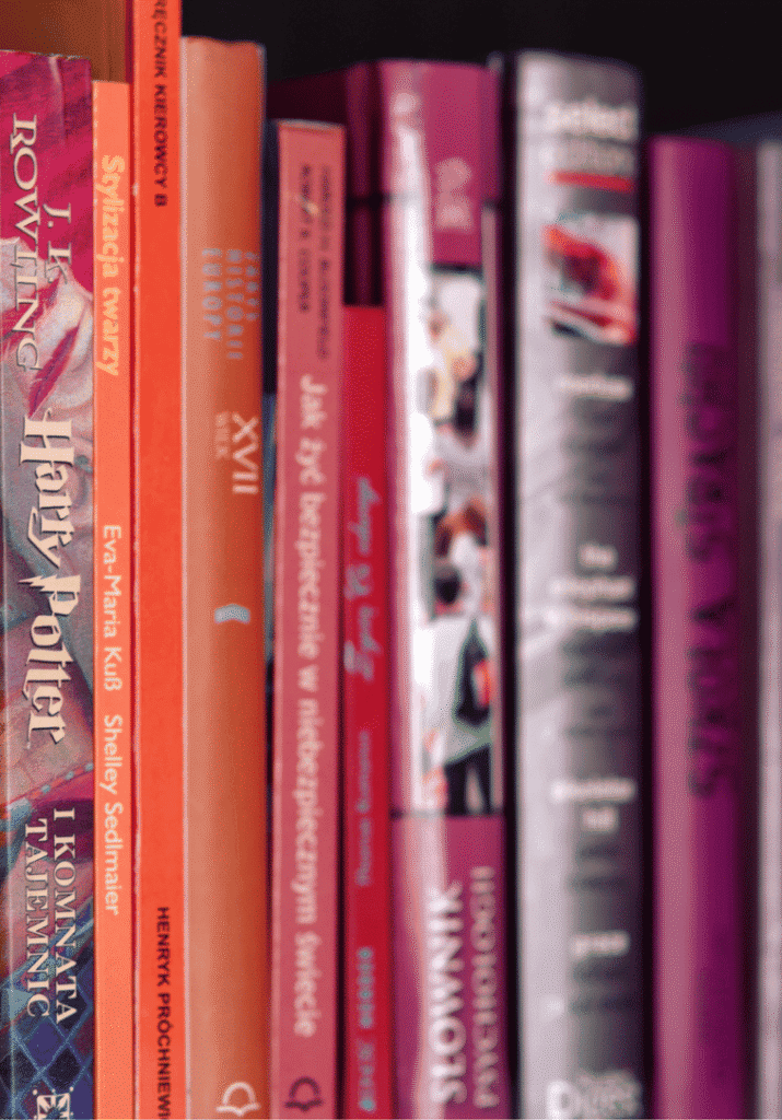 a book shelf with popular books colorful books on it
