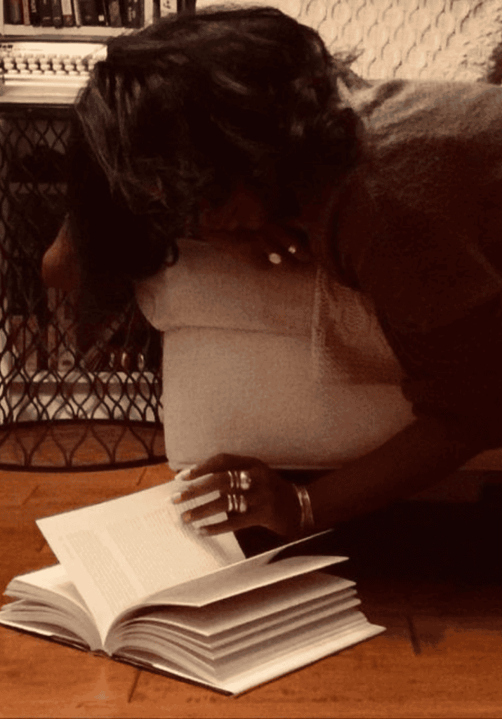 Woman reading a book on her couch, cozy slow burn romance reading moment
