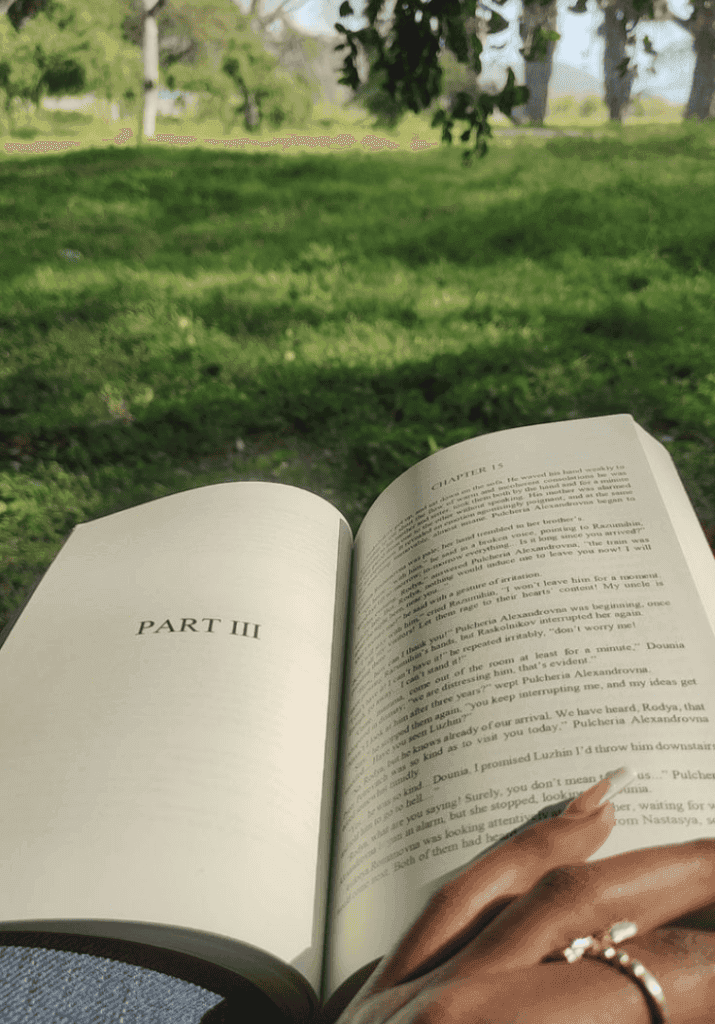a woman reading at the park 